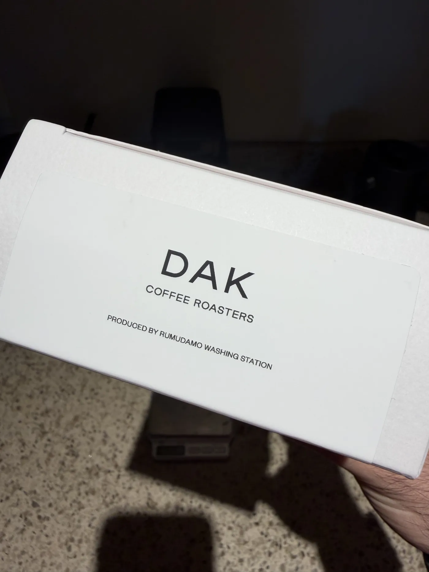 The top of the DAK box, reading "DAK Coffee Roasters, produced by Rumudamo Washing Station."